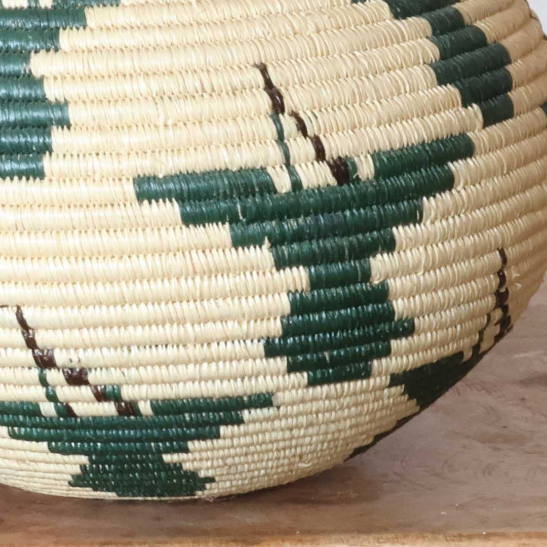 Close-up of intricate ribbed hummingbird weave pattern in emerald werregue palm fiber craftsmanship