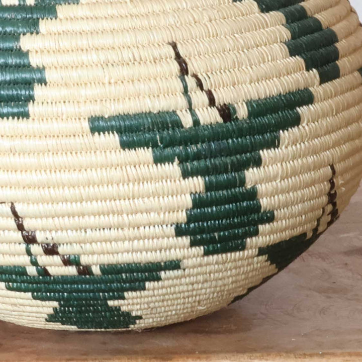 Close-up of intricate ribbed hummingbird weave pattern in emerald werregue palm fiber craftsmanship