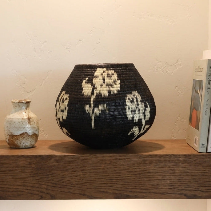 White Rose Vessel, one of one werregue basket handwoven by Wounaan weavers in Chocó, Colombia, styled on a shelf