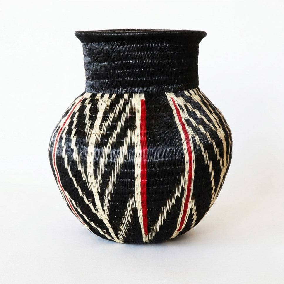 Feather and Ember Jar, one of one werregue basket handwoven by Wounaan weavers in Chocó, Colombia