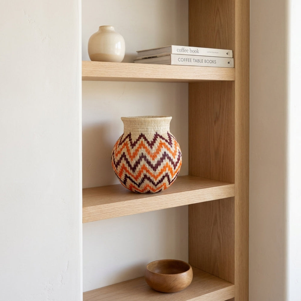 Flame Stitch Jar, one of one werregue basket handwoven by Wounaan weavers in Chocó, Colombia, styled on a shelf