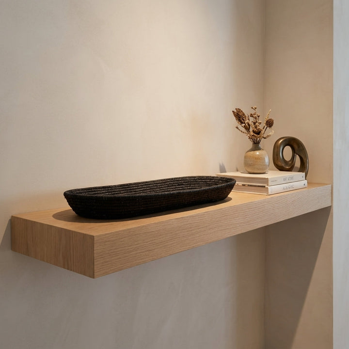Slim Shadow Platter, one of one werregue basket handwoven by Wounaan weavers in Chocó, Colombia, styled on a shelf