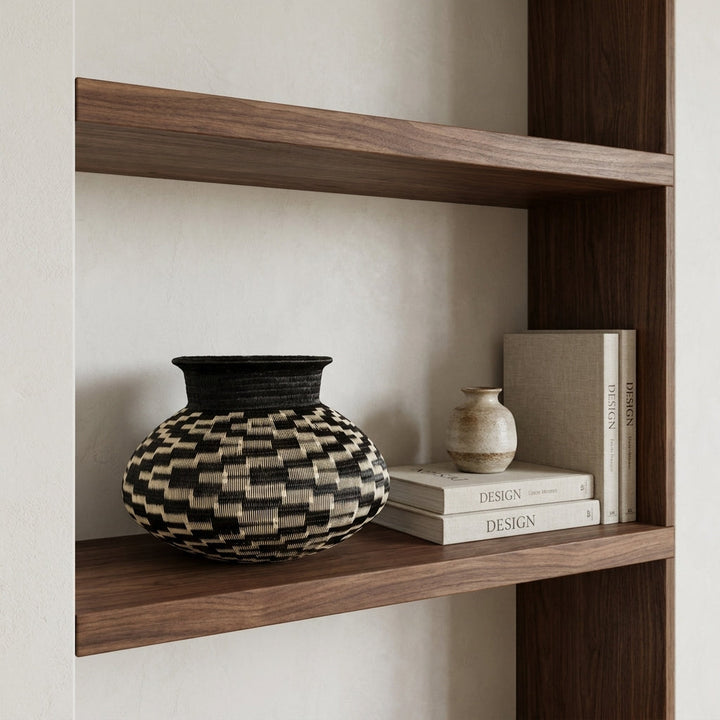 Scattered Steps Jar, one of one werregue basket handwoven by Wounaan weavers in Chocó, Colombia, styled on a shelf