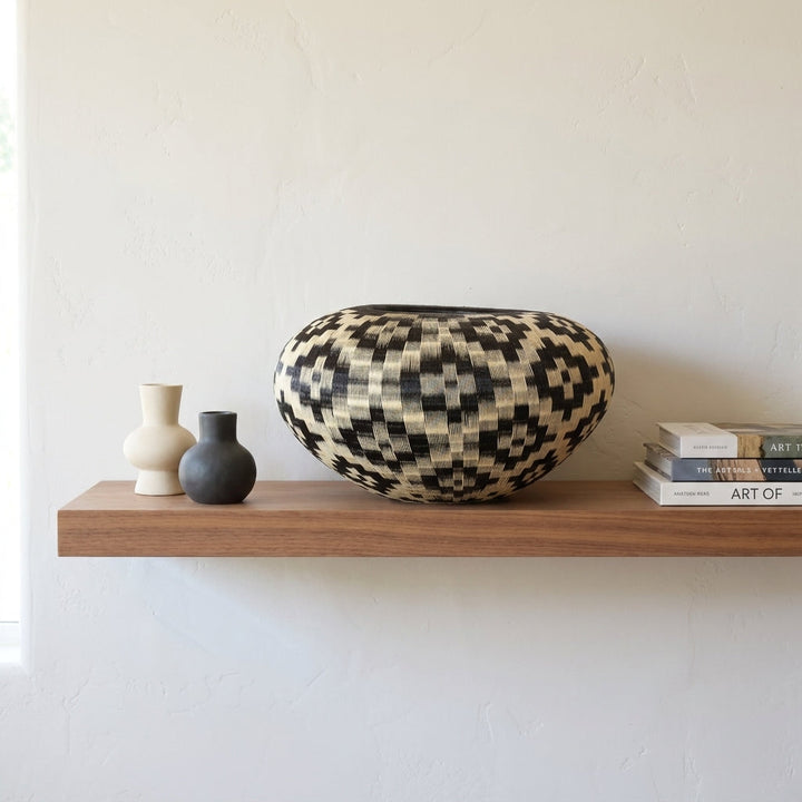 Diamond Field Vessel, one of one werregue basket handwoven by Wounaan weavers in Chocó, Colombia, styled on a shelf