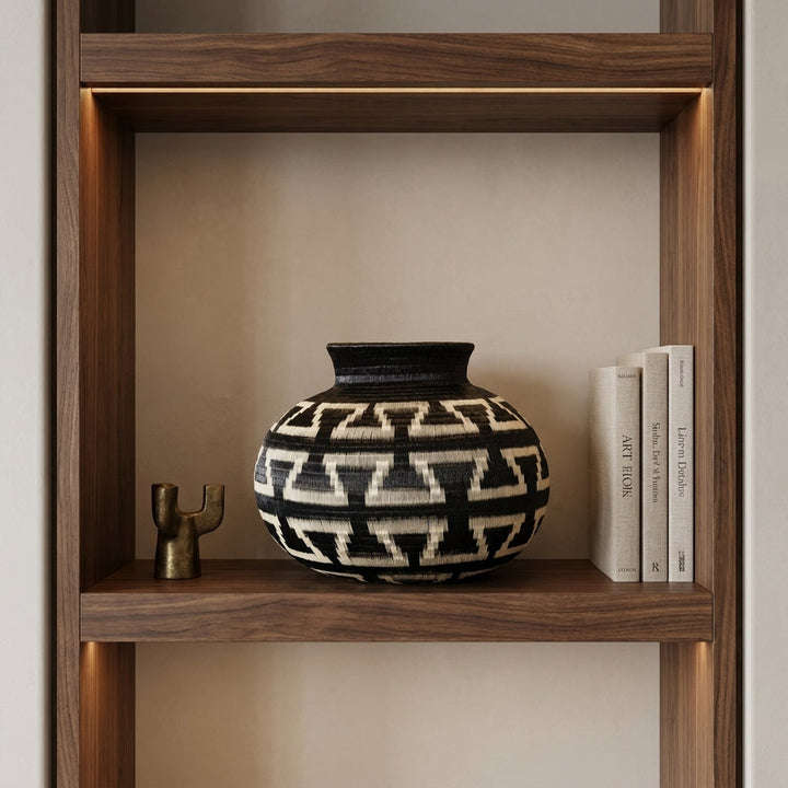 Bold Keys Globe, one of one werregue basket handwoven by Wounaan weavers in Chocó, Colombia, styled on a shelf