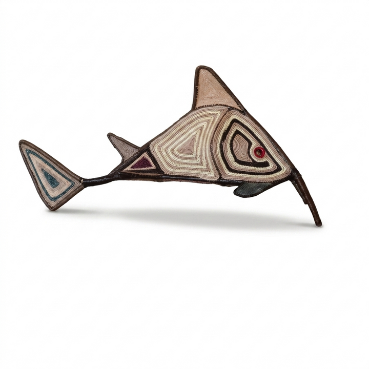 Handwoven Embera needlefish wall art with concentric geometric patterns, side view