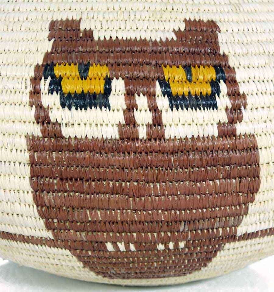 Close-up detail of yellow owl eyes pattern in traditional Wounaan coil weaving technique with natural dyes