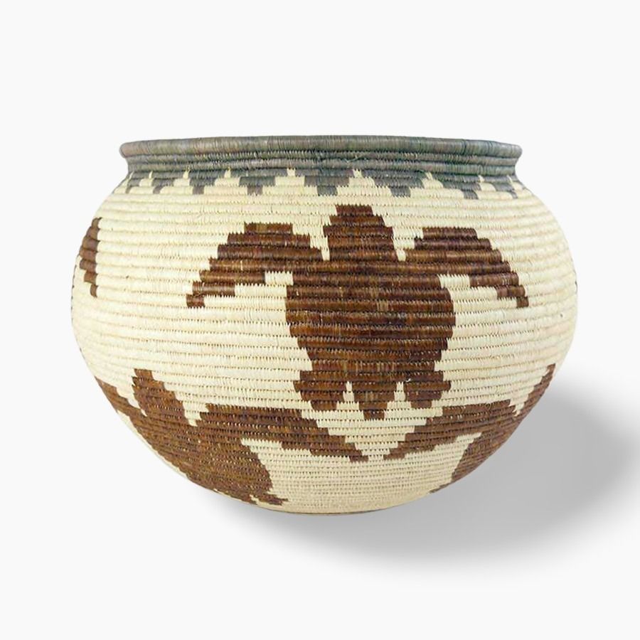 Side angle view of handmade turtle path basket showing depth and traditional weaving craftsmanship
