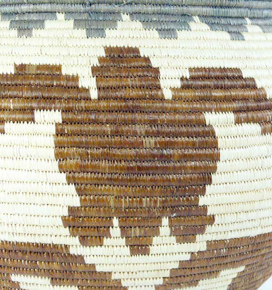 Close-up detail of traditional coiling weave technique showing intricate turtle motif pattern