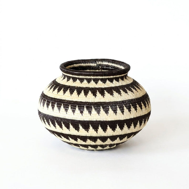 Black and white triangle-band Wounaan basket, close view of serrated geometric pattern in woven palm fiber