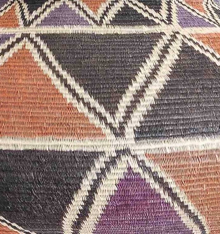 Close-up werregue palm weave showing intricate geometric eclipse pattern craftsmanship detail