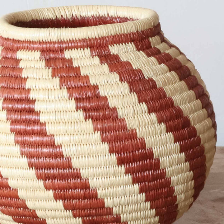 Close-up werregue palm fiber weave showing intricate spiral flame pattern craftsmanship