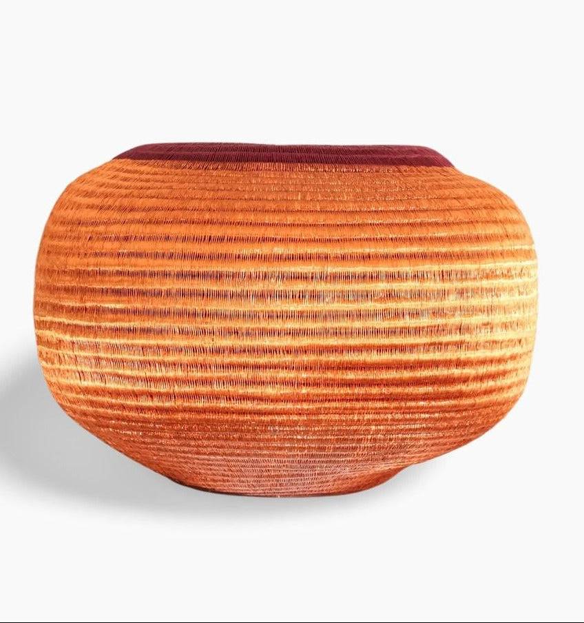 Large decorative woven basket with radiant horizon pattern in natural palm fiber by indigenous artisans