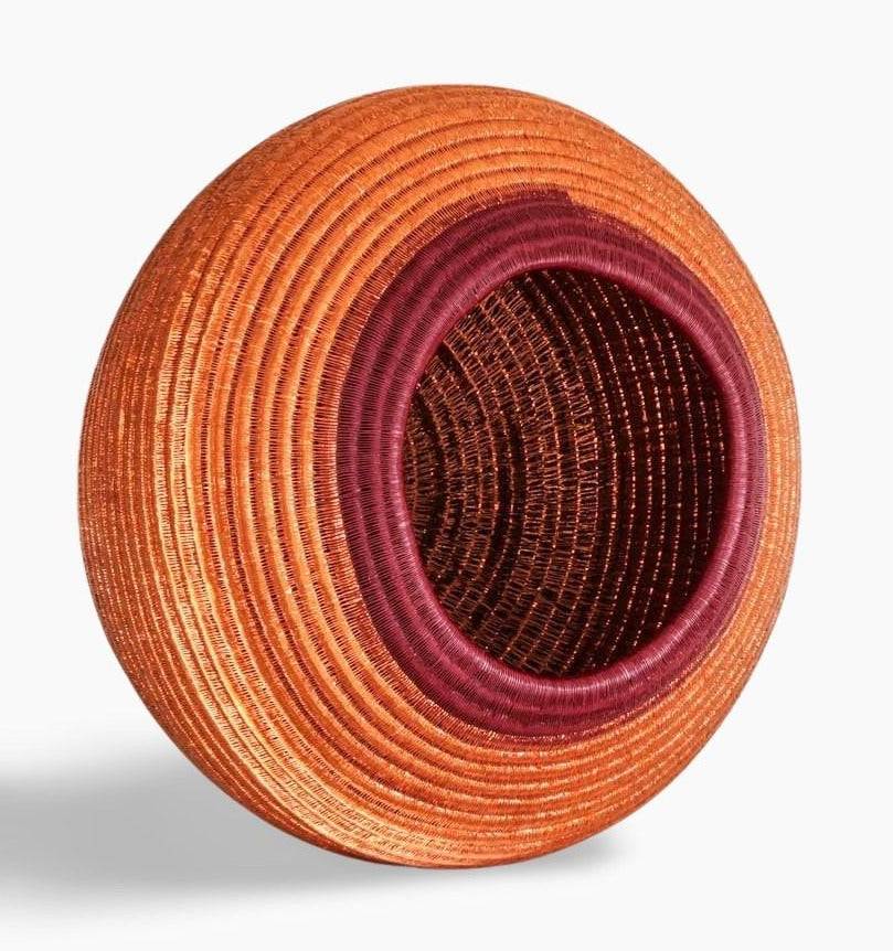 Side angle view of handmade decorative basket showing depth and traditional weaving structure