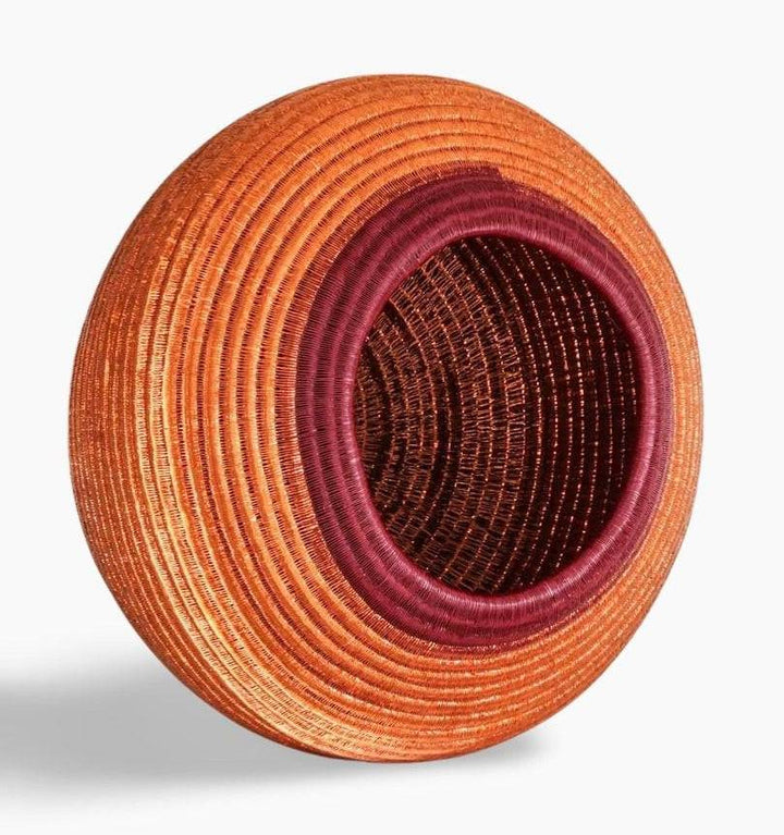 Side angle view of handmade decorative basket showing depth and traditional weaving structure