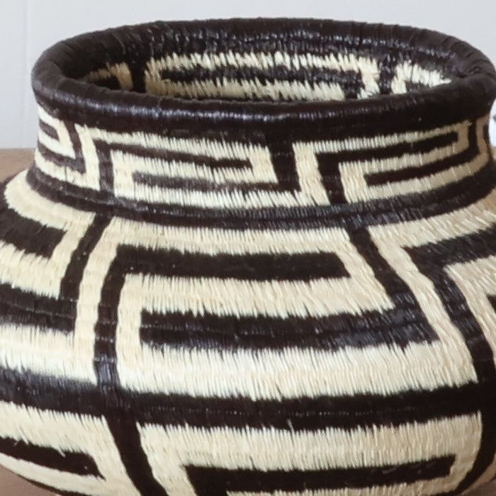 Close-up Cultural Steps geometric weave pattern black palm fiber traditional indigenous craftsmanship