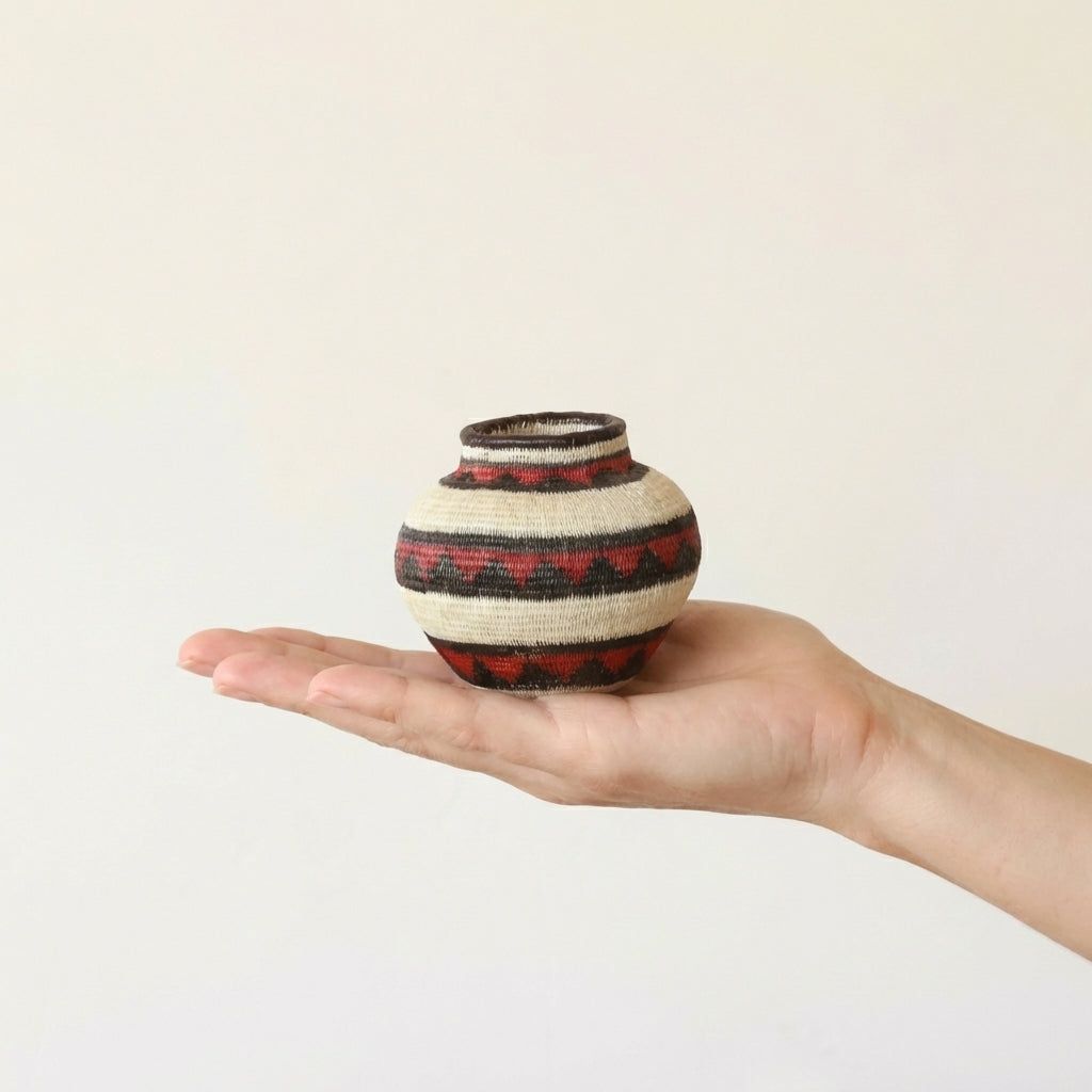Mini woven basket with crimson geometric motifs by Wounaan artisans from Panama Darién rainforest