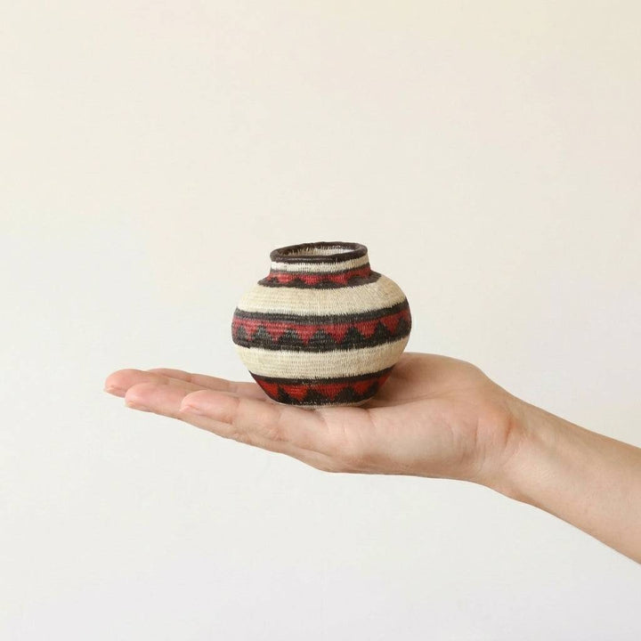 Mini woven basket with crimson geometric motifs by Wounaan artisans from Panama Darién rainforest