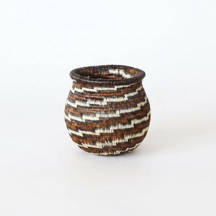 Tiny handwoven Wounaan basket with stepped swirl in espresso brown, rust and cream, flared rim, from Panama