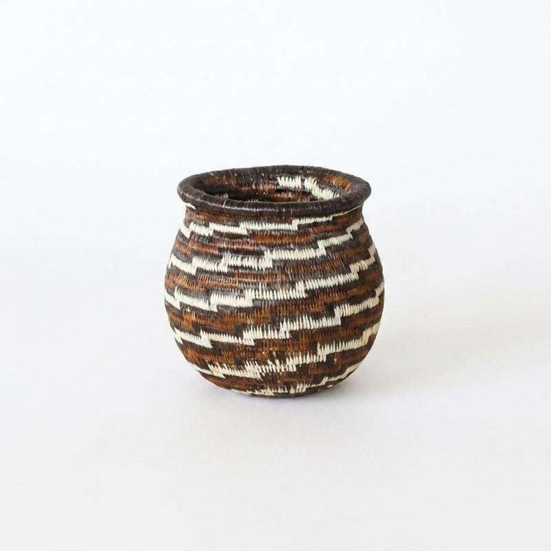 Tiny handwoven Wounaan basket with stepped swirl in espresso brown, rust and cream, flared rim, from Panama