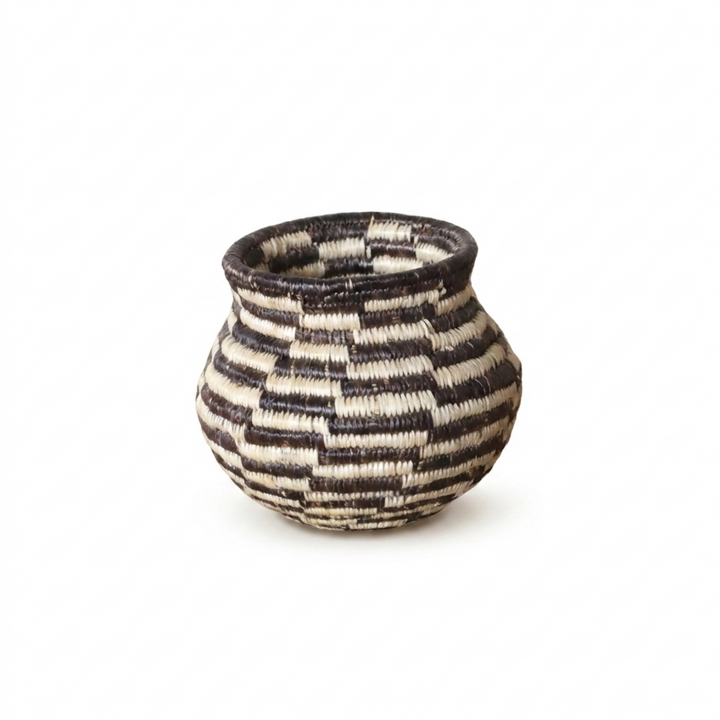 Tiny black and ivory stepped swirl Wounaan basket handwoven in Panama, studio view