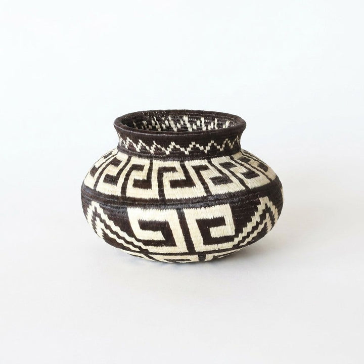 Mini handwoven Wounaan basket with black and ivory Greek-key labyrinth pattern, woven art from Panama's Darién