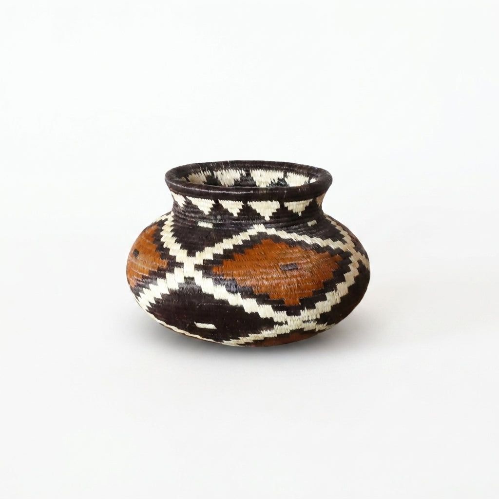 Tiny handwoven Wounaan basket with rust, black and cream stepped diamond pattern from Panama's Darién rainforest