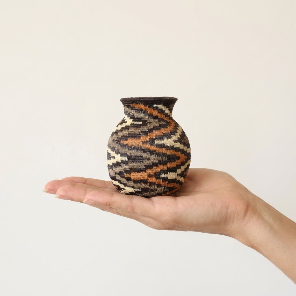Mini decorative basket with golden spiral pattern handwoven by Wounaan artisans from Panama
