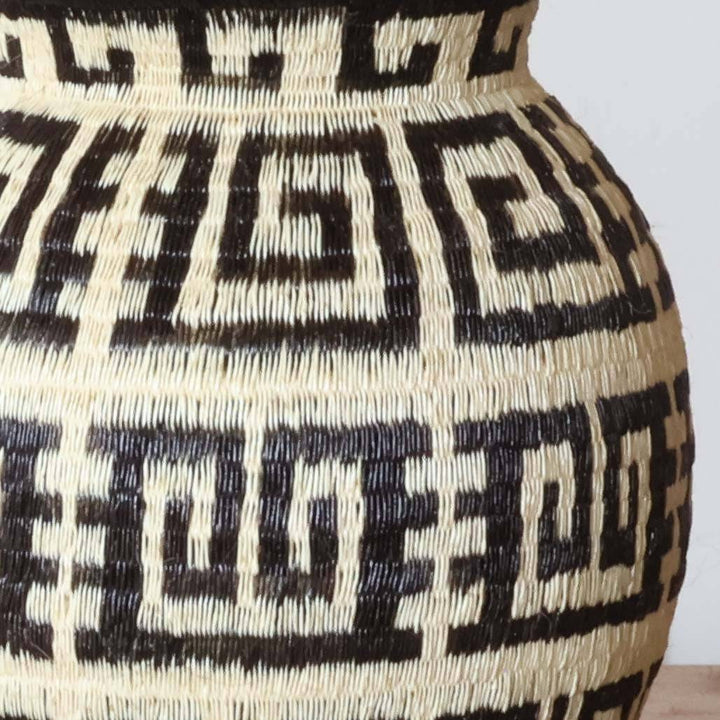 Close-up detail of intricate maze weave pattern showing tight-coil palm fiber craftsmanship techniques