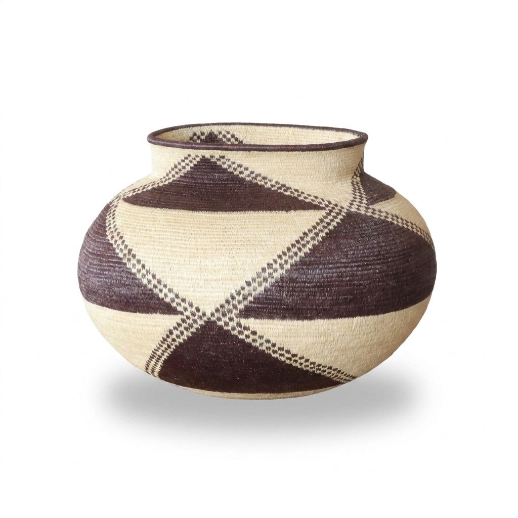 Wide view of brown and cream X-crossing triangle pattern on handwoven Wounaan basket, Panama woven art