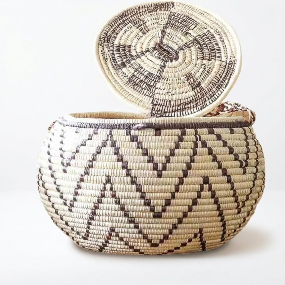 Wide woven basket with its coiled lid propped against it, brown chevron pattern
