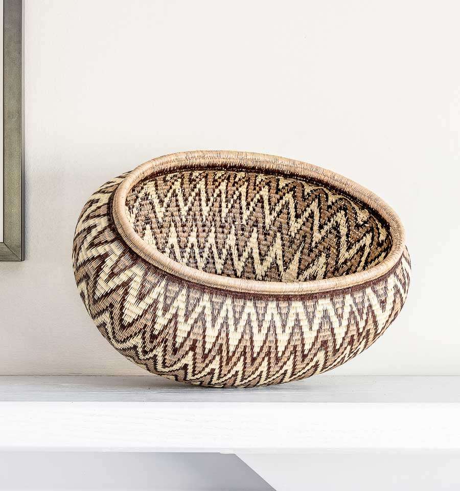 Large grey oval decorative basket with geometric chevron pattern handwoven in Panama