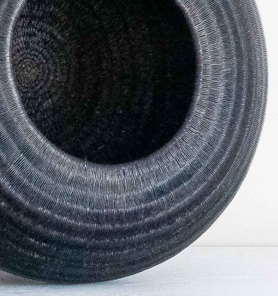 Close-up detail of the weave on the Low Round Black Wounaan basket from Panama