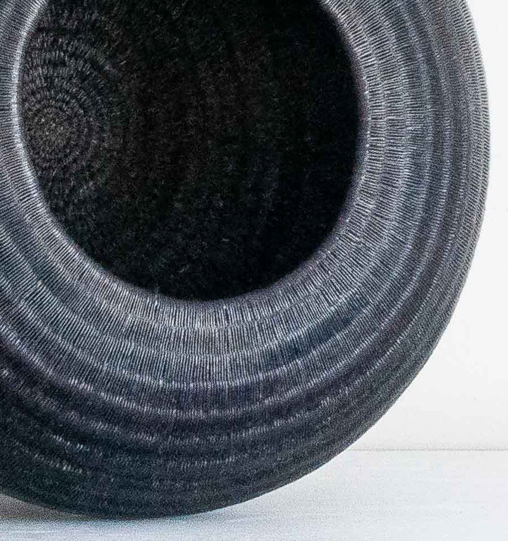 Close-up detail of the weave on the Low Round Black Wounaan basket from Panama
