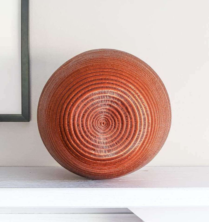 rear view of tapered woven basket showing elegant curved silhouette and natural fiber texture