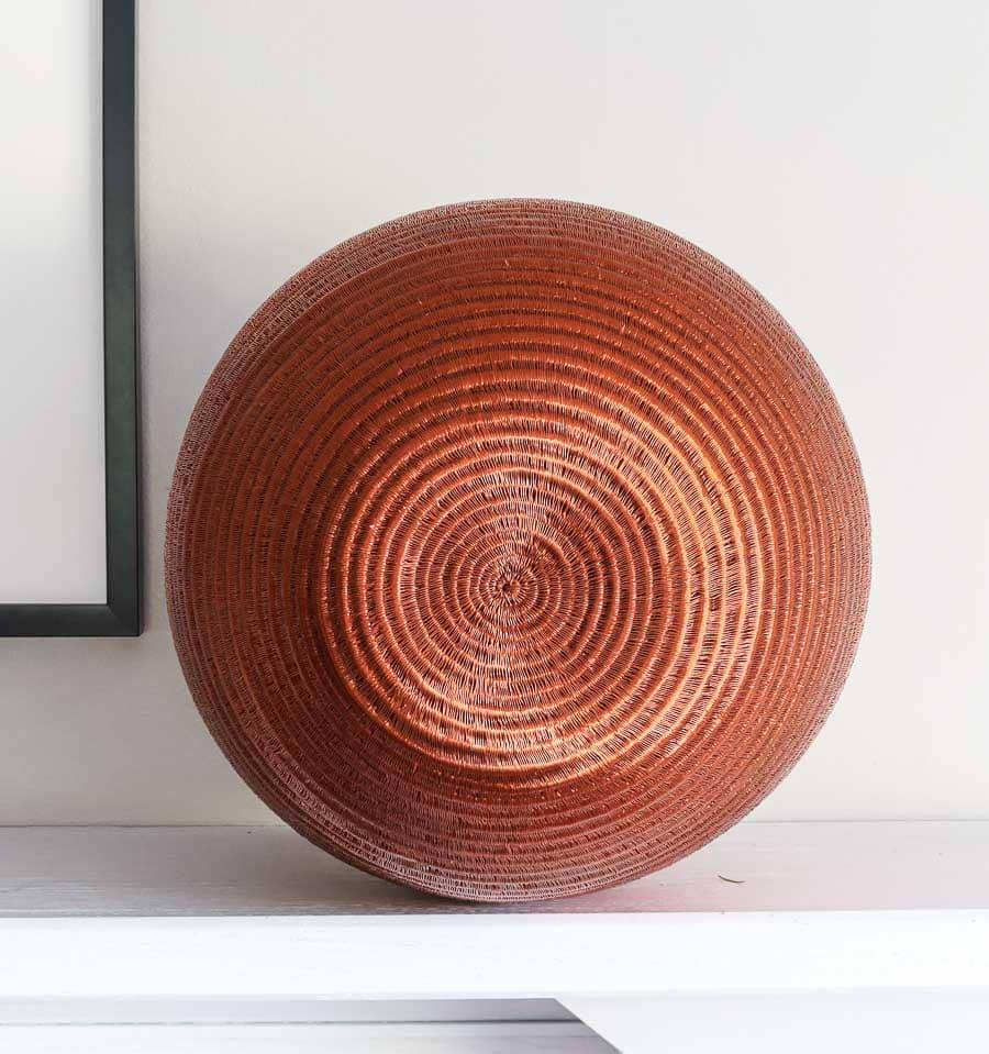 rear view of large decorative copper vessel basket showing sculptural vessel form