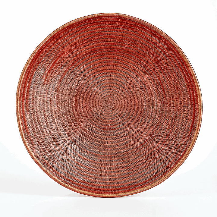 Large copper woven decorative plate with intricate patterns by master artisan Plinio Opua