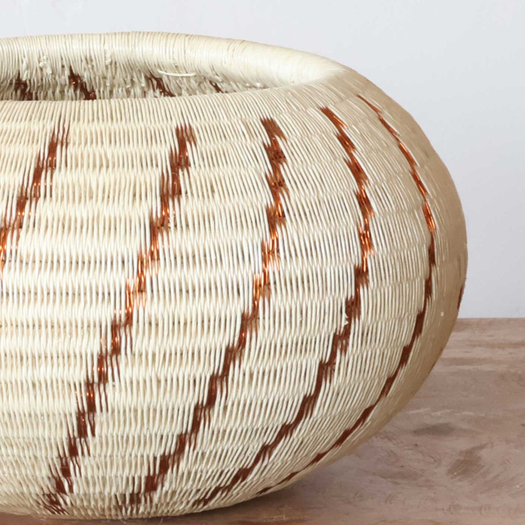 Close-up handwoven werregue palm fiber spiral pattern copper tones Wounaan basket craftsmanship detail