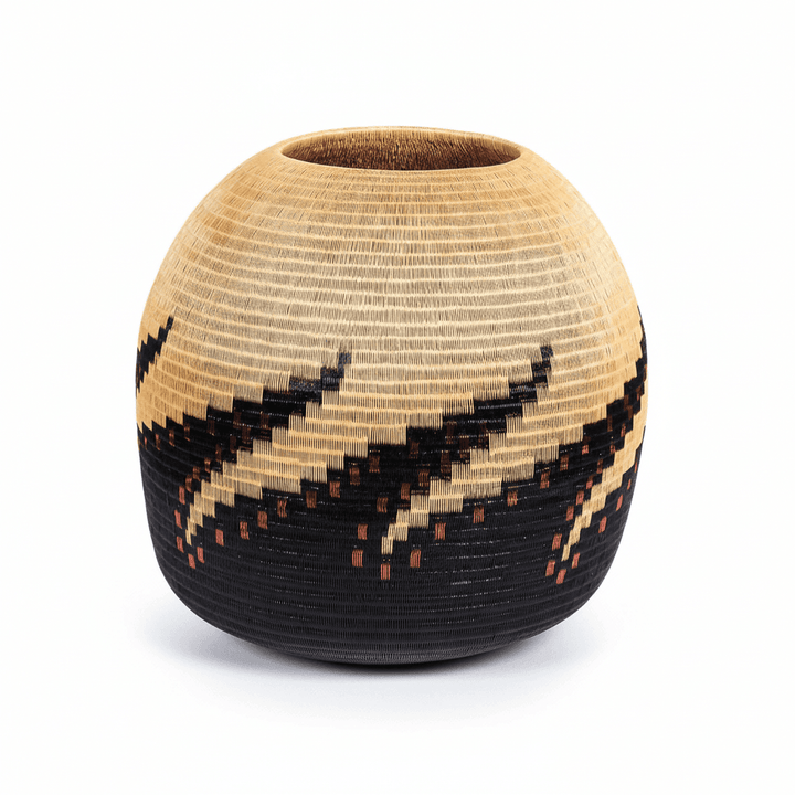 Side view of woven vessel showing three-dimensional octopus form in natural palm fiber