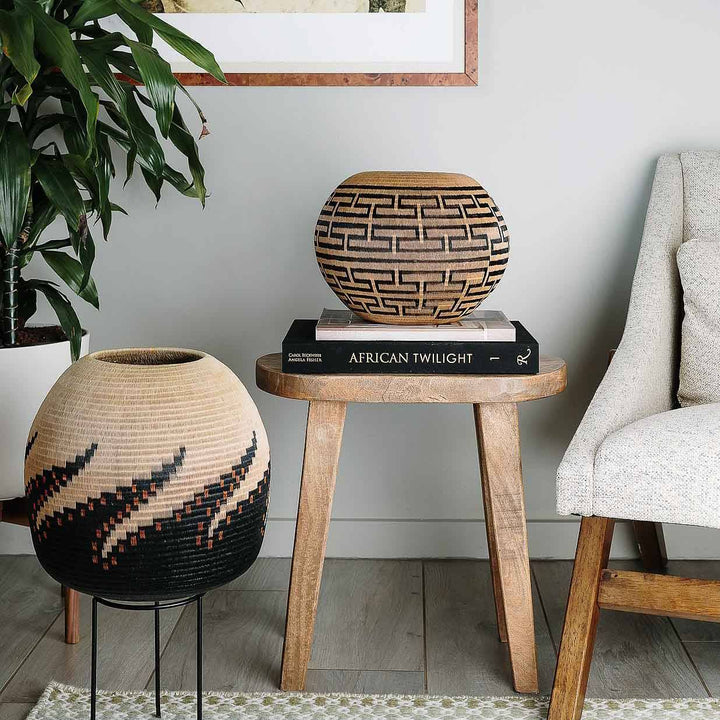 Sculptural Colombian Wounaan basket displayed on wooden side table as decorative accent