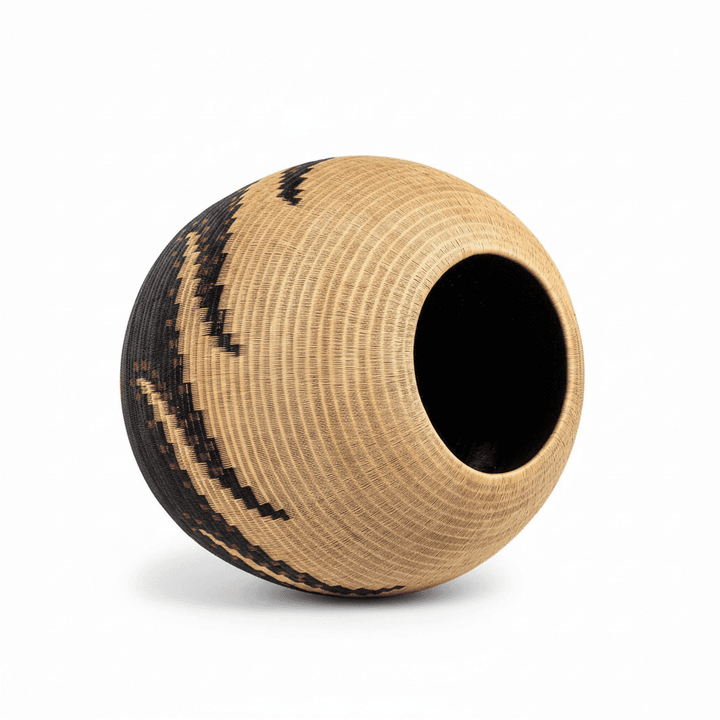 isometric view of woven vessel showing three-dimensional octopus form in natural palm fiber