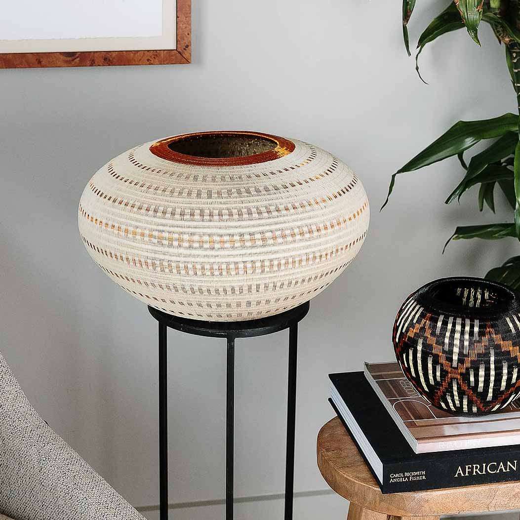 Large decorative basket with vertical striped pattern handwoven by Wounaan artisans from Panama palm fiber