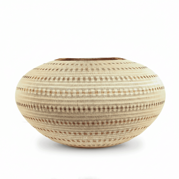 Side view of handmade basket showing three-dimensional vessel form and cascading vertical current design