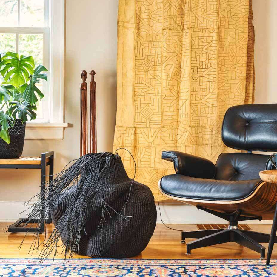 Decorative black wavy basket displayed as accent piece in modern living room interior