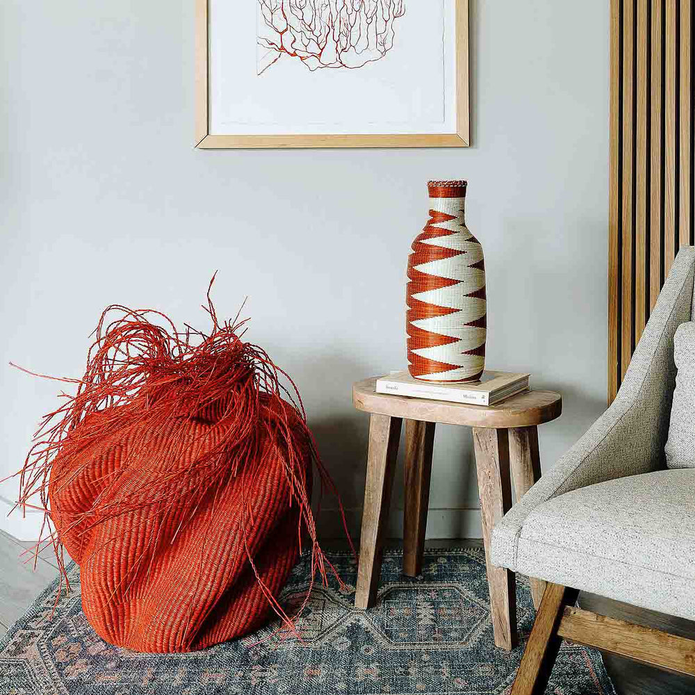 Handmade Rwanda mini basket vase displayed on wooden console in boho home decor setting