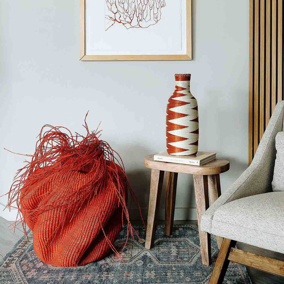 Handmade Rwanda mini basket vase displayed on wooden console in boho home decor setting