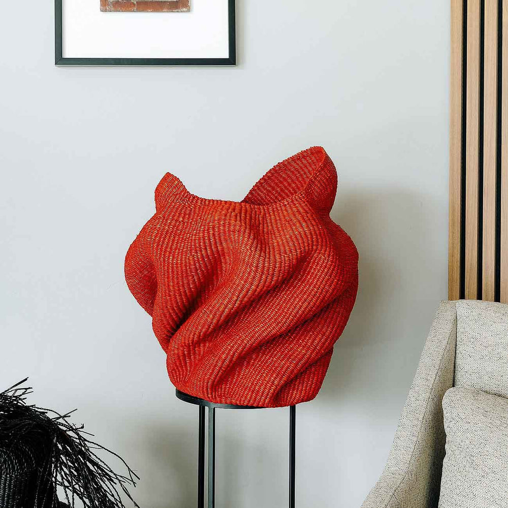 Handmade basket displayed as sculptural decor in modern interior setting