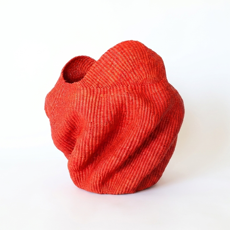 Red wavy sculptural basket, third angle on white