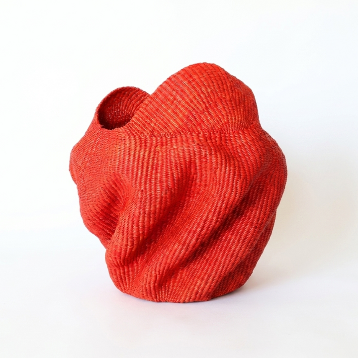 Red wavy sculptural basket, third angle on white