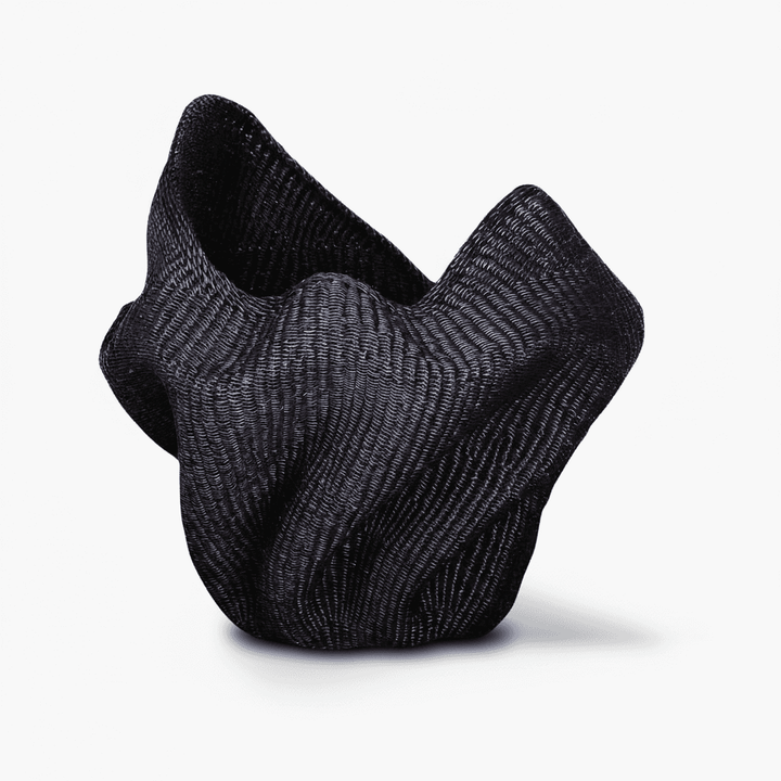 Side angle showing curved wave silhouette and dimensional form of woven basket